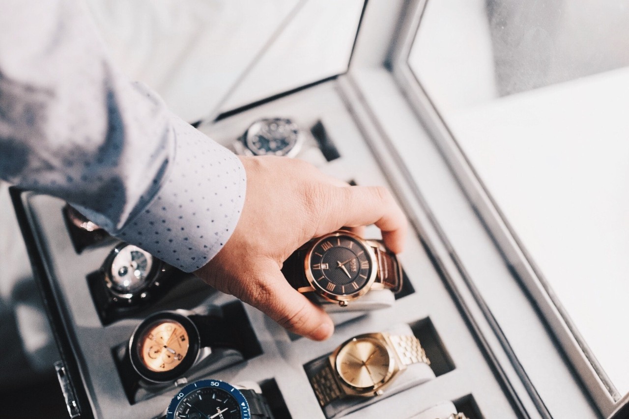 A father selects a watch from his collection to wear for the day