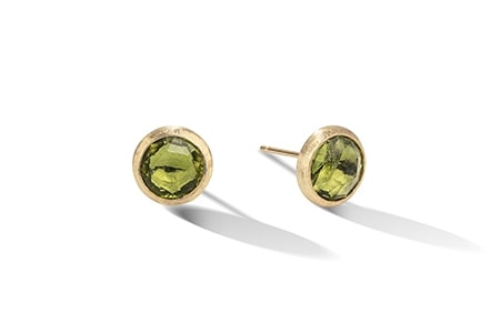 A pair of peridot stud earrings from Marco Bicego feature a bezel setting