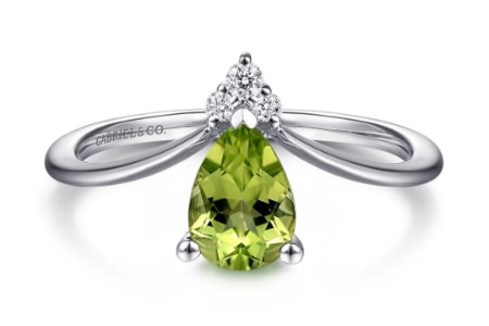 A Gabriel & Co. fashion ring features a pear-shaped peridot gemstone